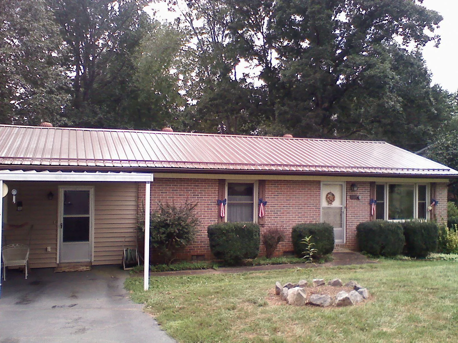 Bronze metal roof and carport on a brick ranch home — Roof Repair work by our crew in Valhermoso Springs