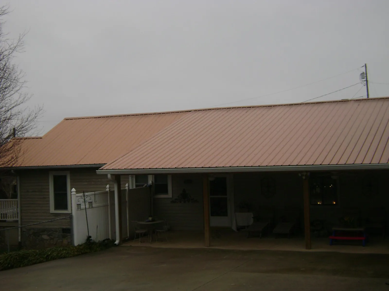 Copper toned metal roof over a wide covered patio in Valhermoso Springs